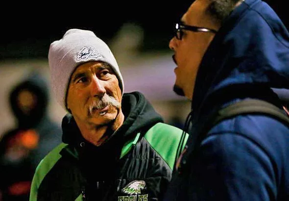 In the fall of 2023, Laney coach John Beam speaks with Oakland Section commissioner Franky Navarro before the Silver Bowl, the annual McClymonds vs Oakland Tech game and the Oakland Athletic League football championship game at McClymonds High School in Oakland. Beam was shot on Thursday and has died at the age of 66. (Joseph Dycus/Bay Area News Group)