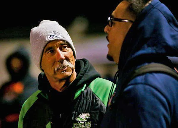 In the fall of 2023, Laney coach John Beam speaks with Oakland Section commissioner Franky Navarro before the Silver Bowl, the annual McClymonds vs Oakland Tech game and the Oakland Athletic League football championship game at McClymonds High School in Oakland. Beam was shot on Thursday and has died at the age of 66. (Joseph Dycus/Bay Area News Group)